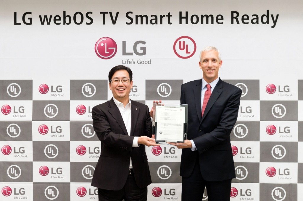Sam Kim, senior vice president and head of TV product planning at the LG Electronics Home Entertainment, and Jason Fischer, president and managing director of UL's Asia Pacific, hold up the verification certificate from UL.