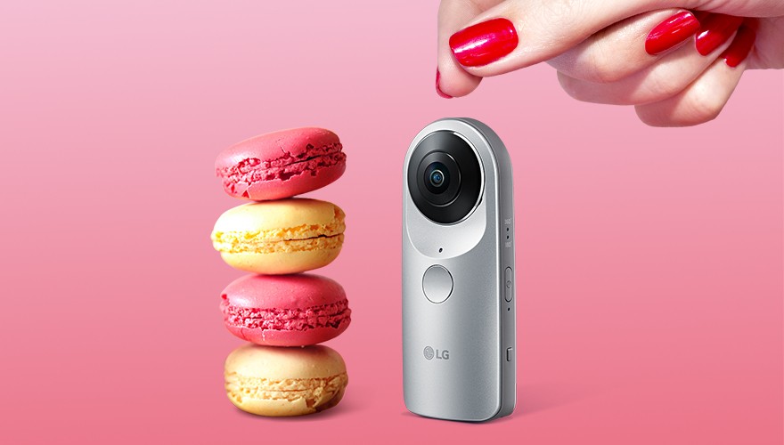 LG 360 CAM positioned next to a stack of macaroons with a woman’s hand visible above