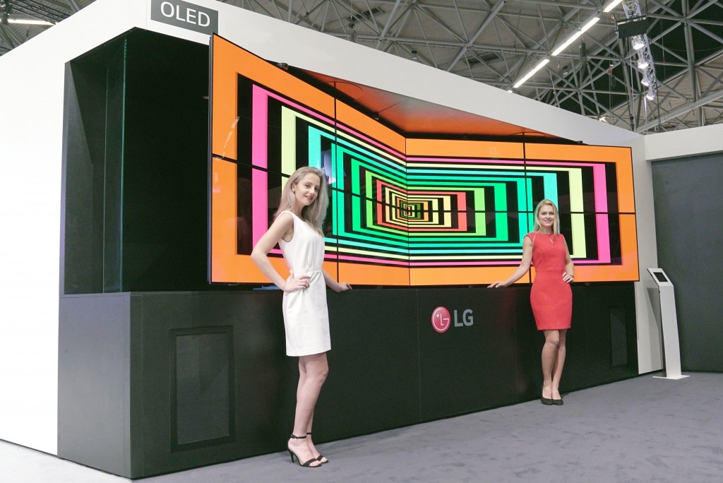 Two models are presenting LG Flexible Open Frame OLED Singage.