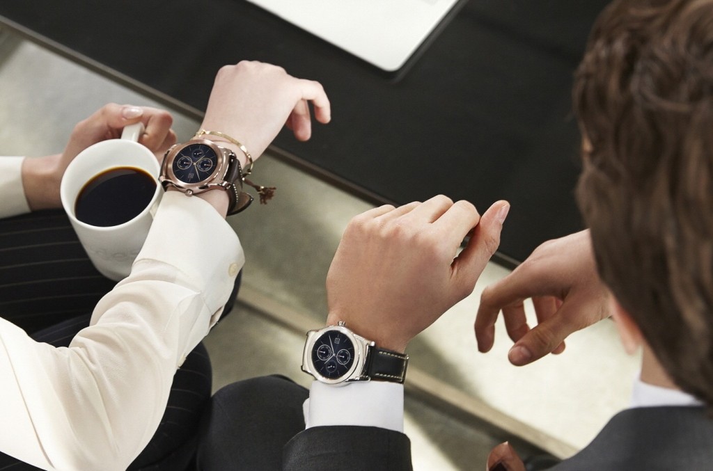 Male and female business people wearing LG Watch Urbane and enjoying a cup of coffee