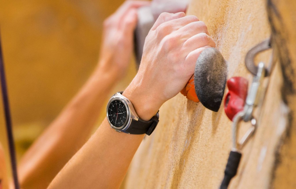 LG Watch Urbane 2 shown on wrist of person doing in-door rock climbing