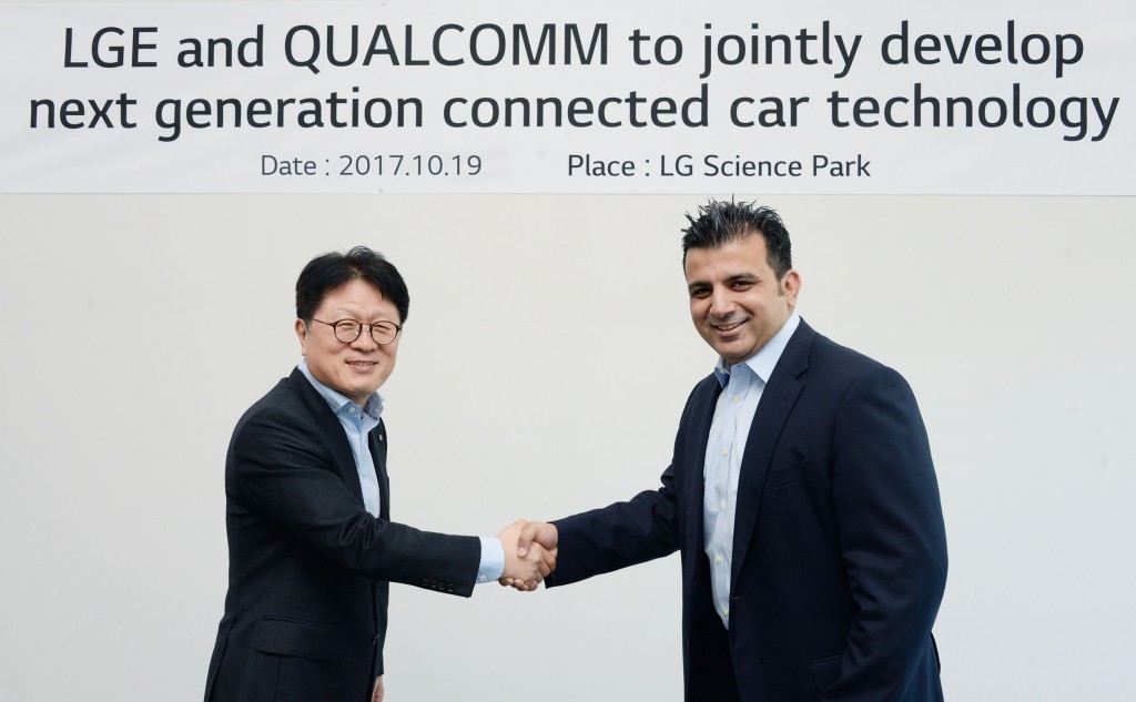 Kim Jin-yong, executive vice president of LG’s Vehicle Components Smart Business Unit, shake hands with Nakul Duggal, vice president of product management at Qualcomm Technologies, Inc, to celebrate the new agreement