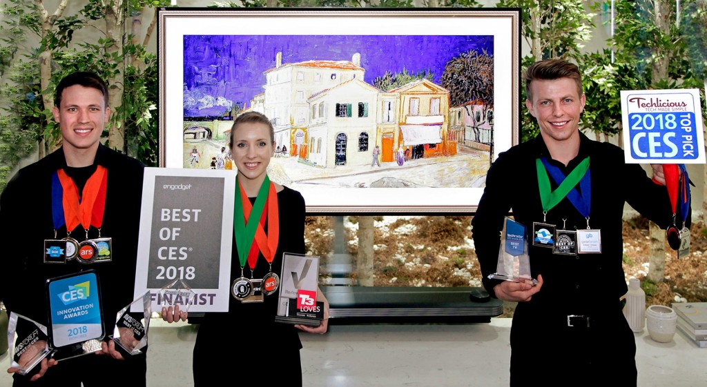 Models pose with the awards from Engadget, T3, Techlicious and more after LG won Best TV product honors at CES 2018.