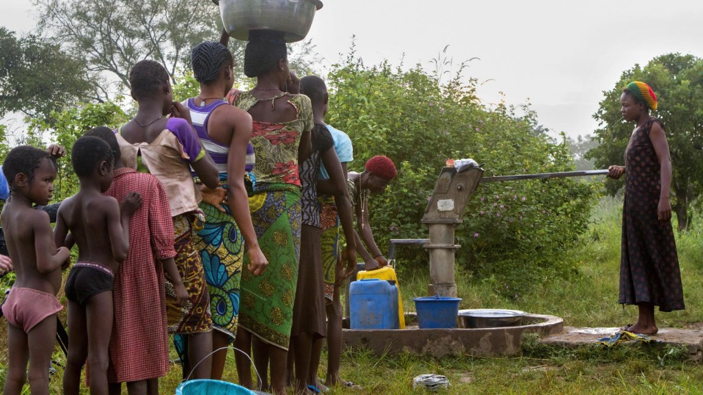 People wait in line to fetch the water from the public well.