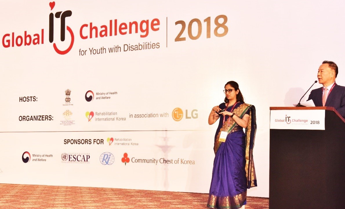 Two presenters announce the start of the 8th Global IT Challenge for Youth with Disabilities on stage, which was sponsored by LG