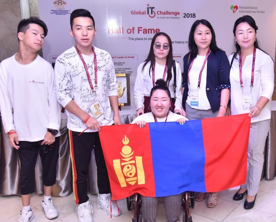 A group photo of the Mongolian participants holding up their national flag