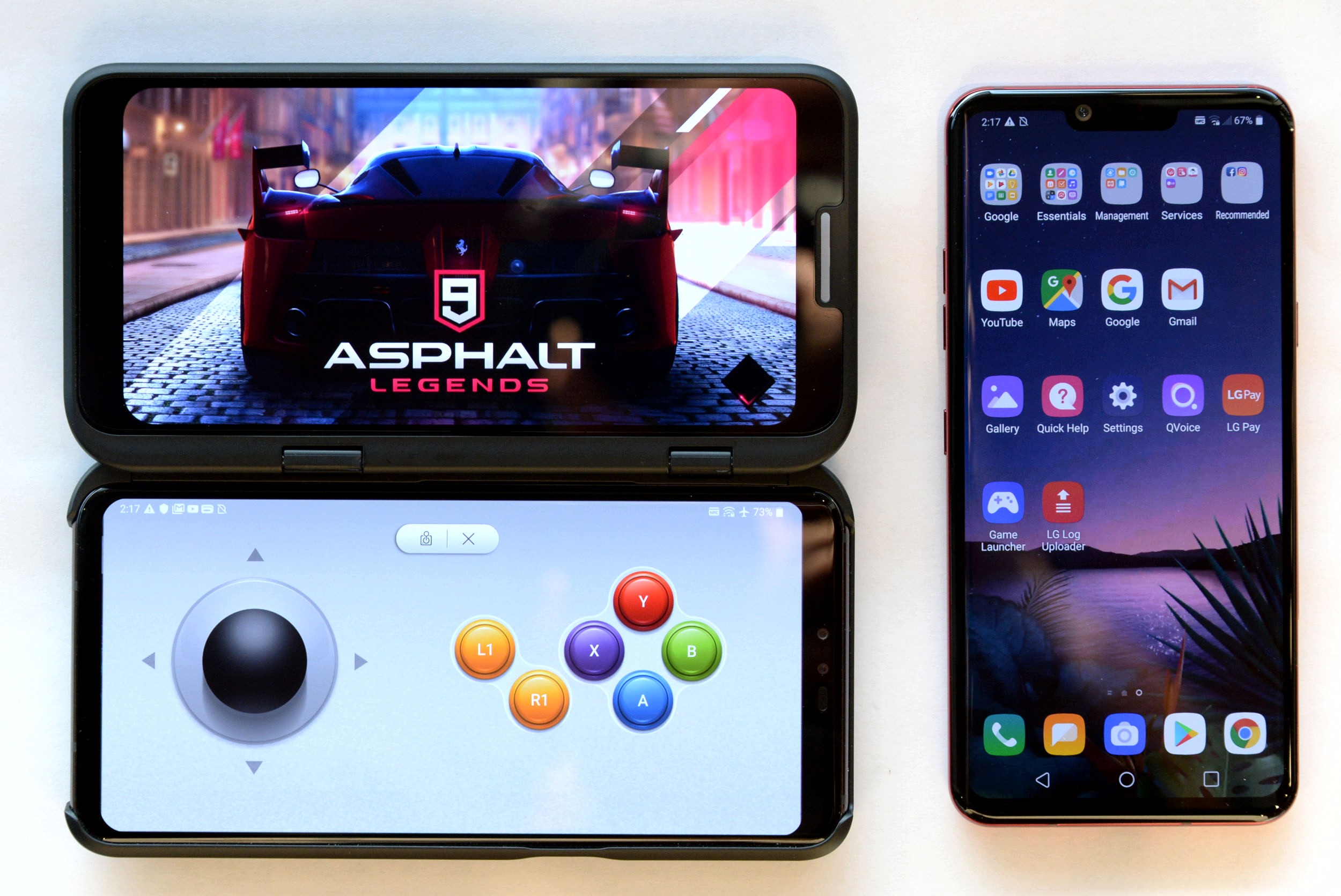 The front view of the LG V50 ThinQ 5G connected to the LG Dual Screen, with the Asphalt 9 Legends game on the top and LG Game Pad on the bottom, next to the LG G8 ThinQ