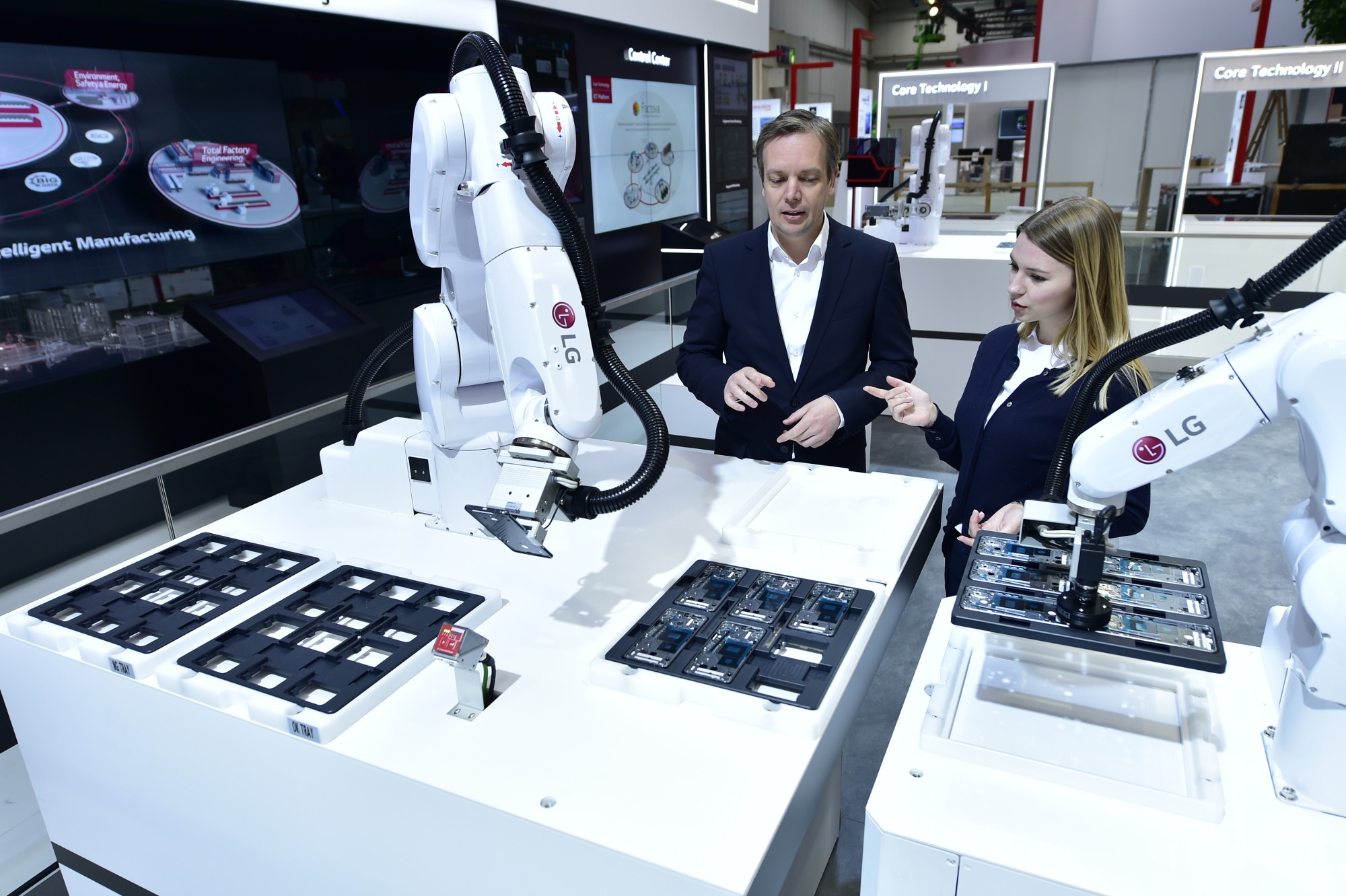 Models pose with the 6-axis robot utilizing Automated Guided Vehicle (AGV).