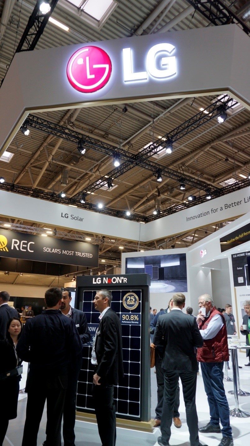 A group of visitors talk to each other at the entrance of LG’s booth at Intersolar Europe 2019