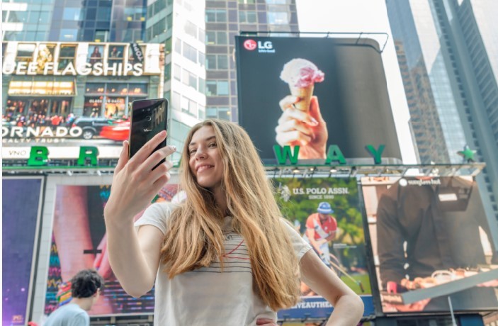 A woman takes her selfie with the LG V50 ThinQ in Times Square, New York.