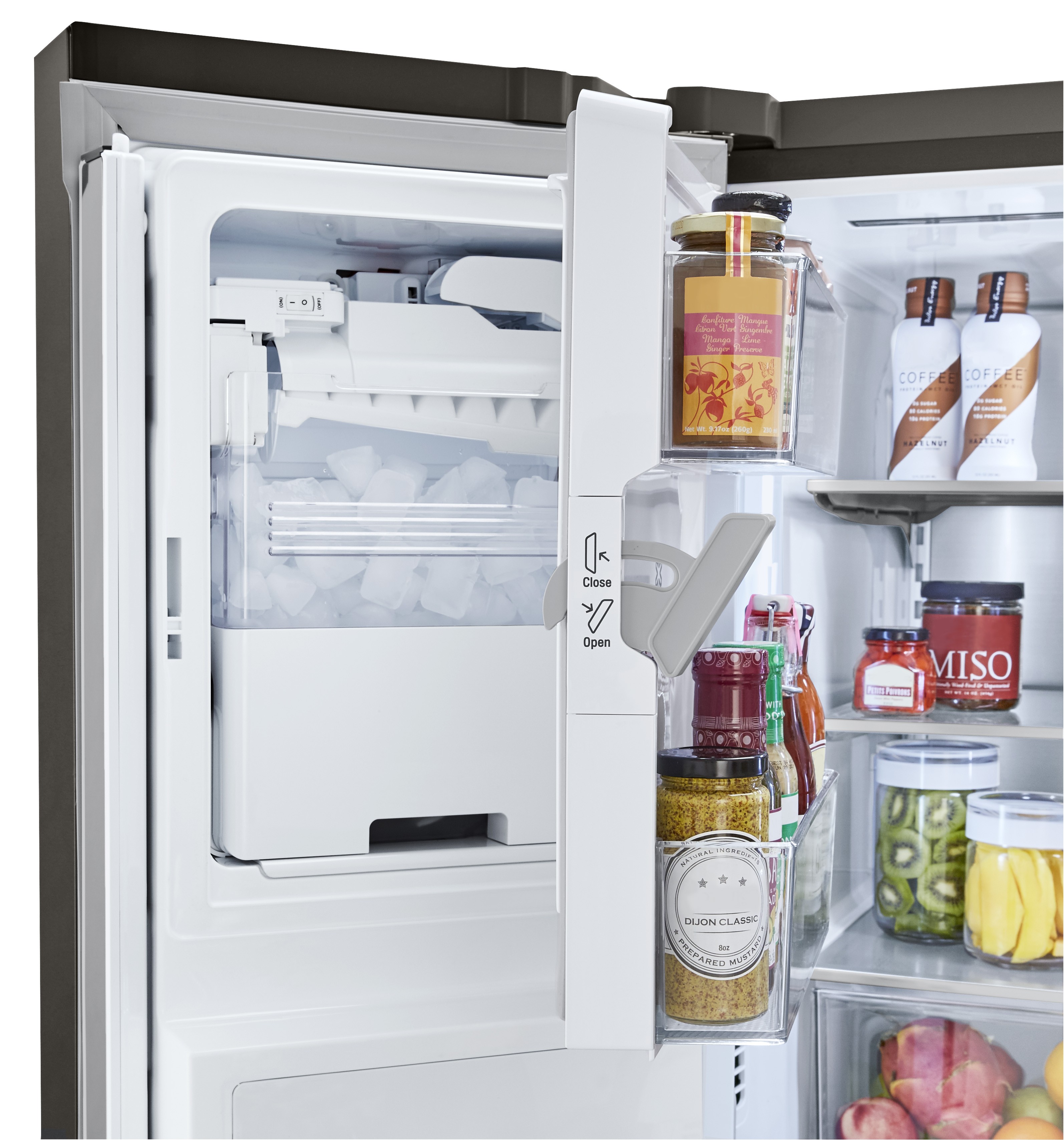 LG refrigerator partially opened to show the interior of its door-ice maker.