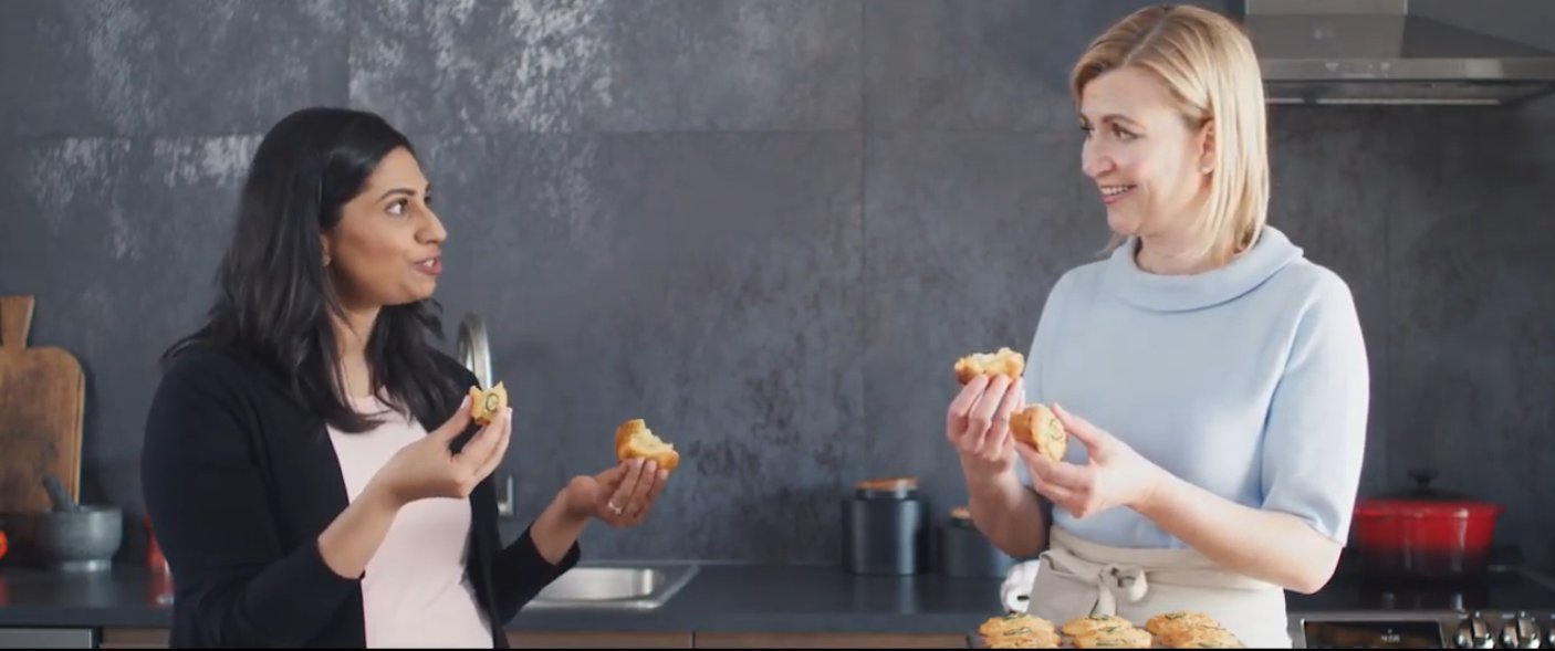 Two ladies stand next to each other and discuss the food they cooked using the LG ProBake Convection® oven.