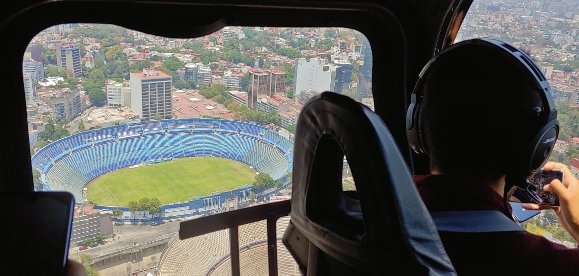 The pilot looks down to the Azul Stadium from the helicopter flying in the sky.