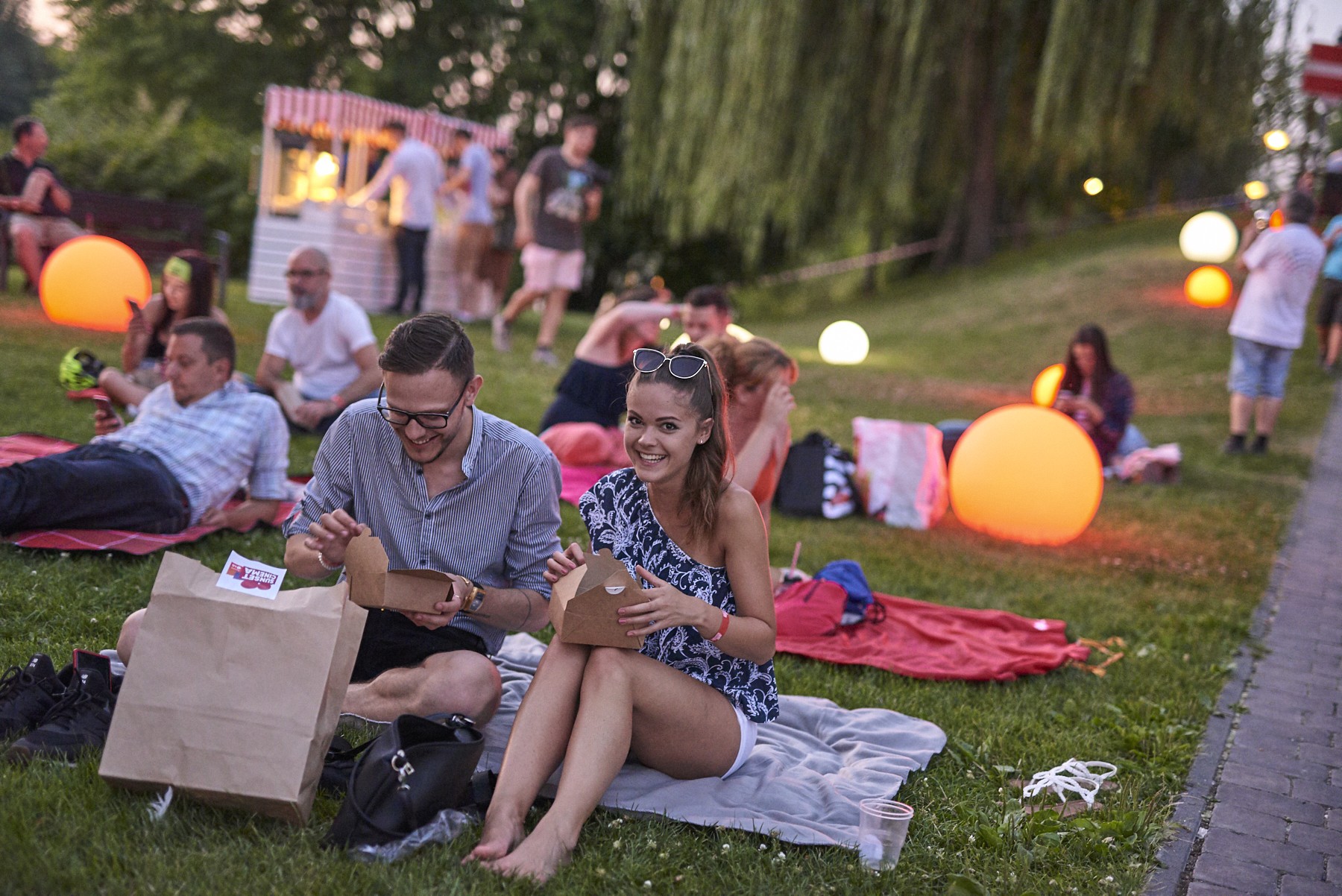 A couple look to be having fun as they open their food boxes at the LG Sunset Cinema event