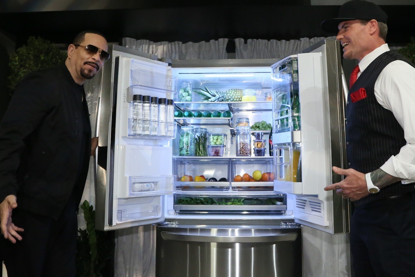 World-famous rappers, Vanilla Ice and Ice-T, hold open the doors of the LG InstaView™ Door-in-Door® Refrigerator with Craft Ice at the Craft Ice House hosted by LG event.