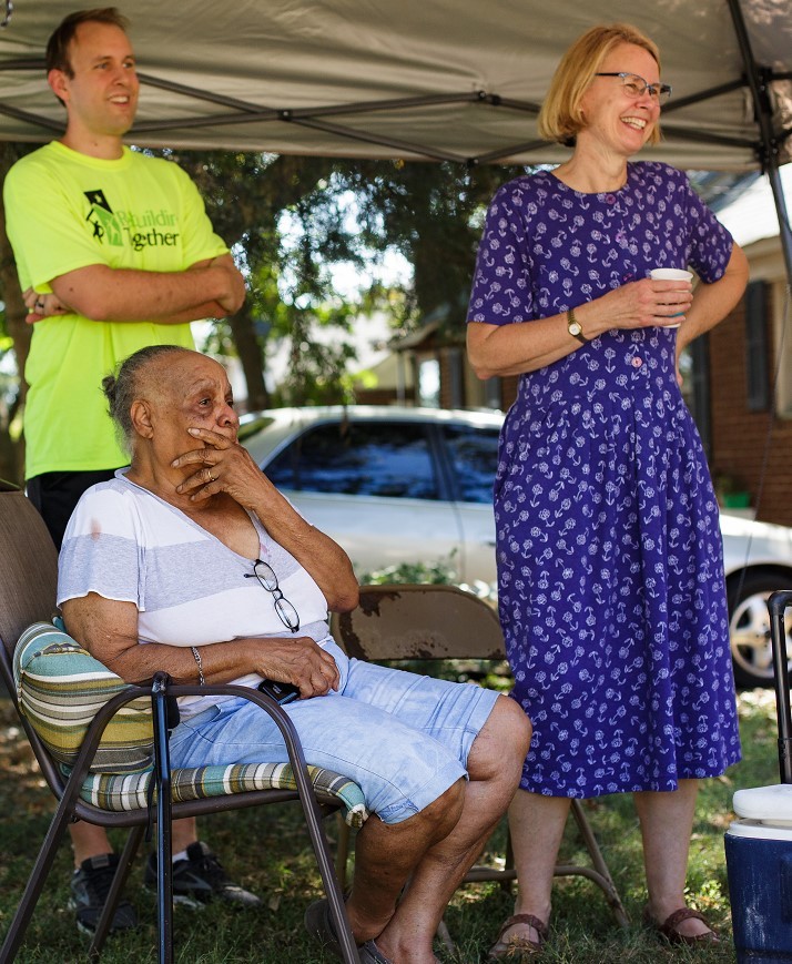 A view of volunteers and a resident of Charlotte’s Druid Hills neighborhood who smile during the event