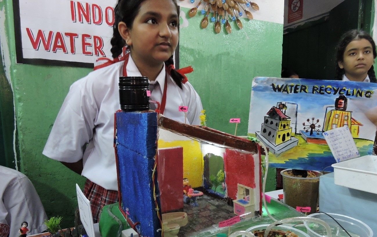 Two girl students give their presentations about the water conservation and the importance of safe drinking water.