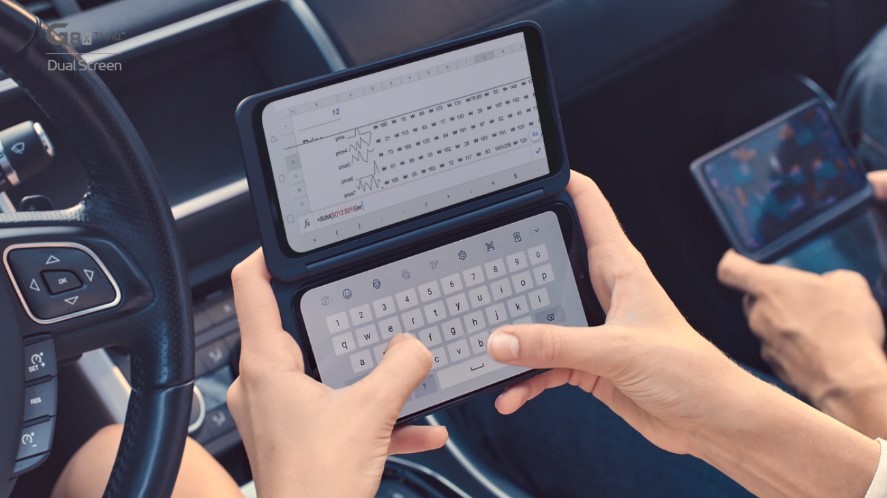 Two people using LG G8X ThinQ with Dual Screen while in a car.