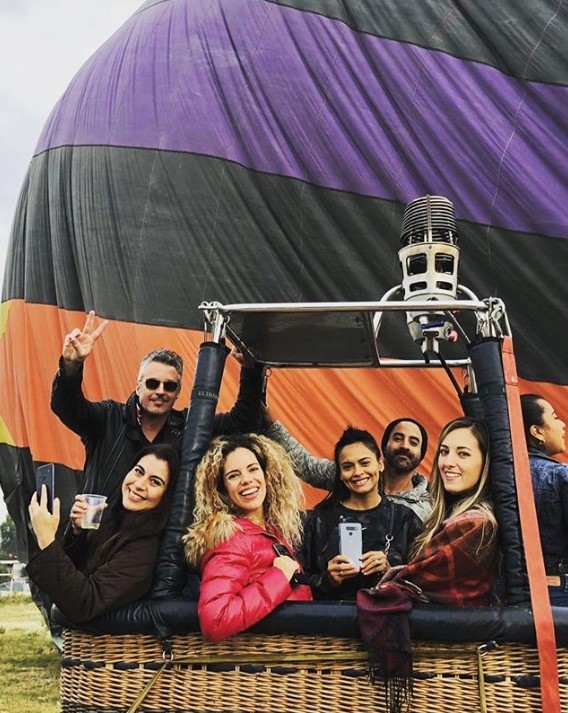 A group of influencers pose with their LG smartphones while in a hot-air balloon right before taking off.