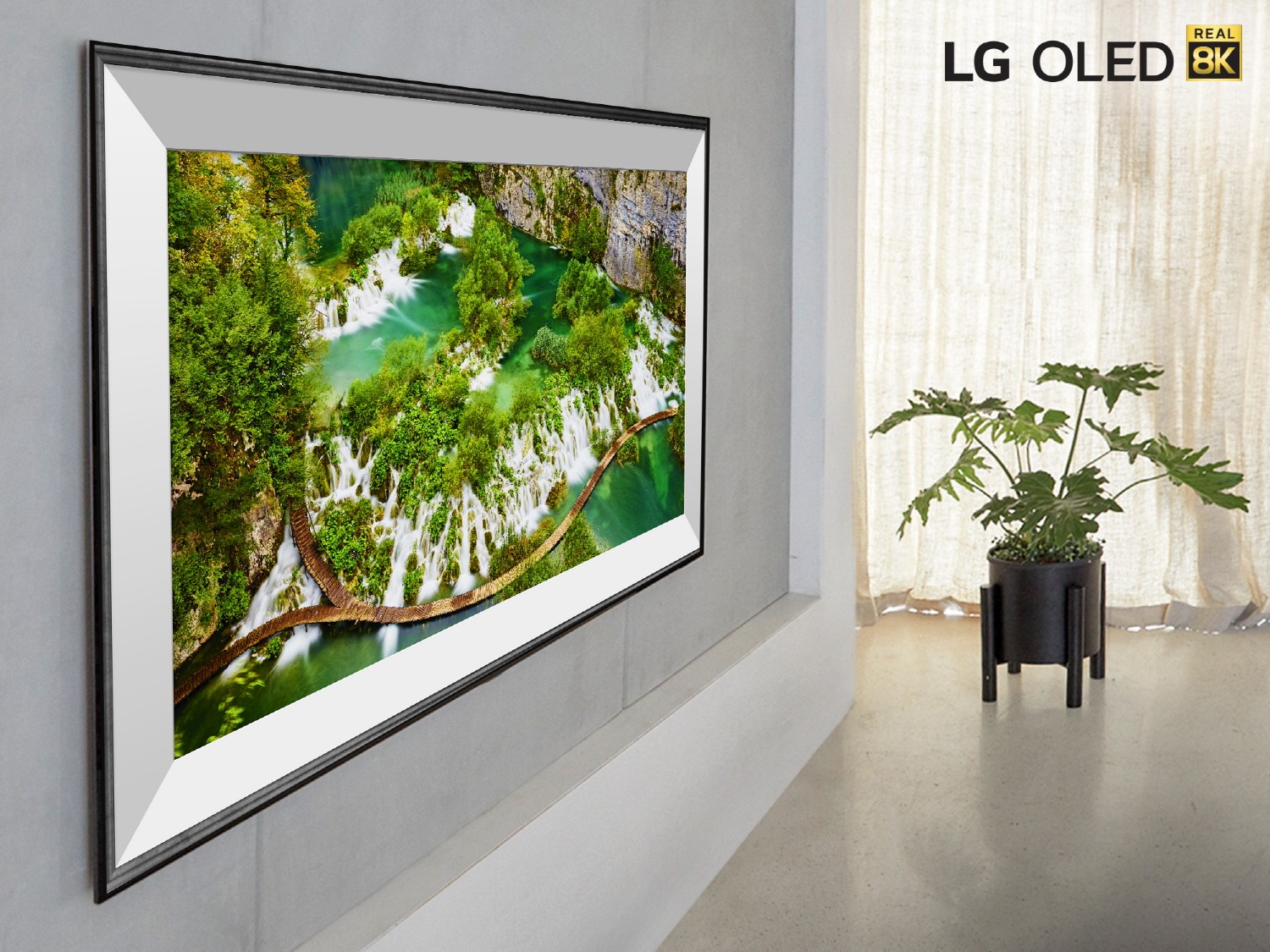 A closer look at LG’s 77-inch 8K OLED TV model ZX hanging flush on a living room wall, with the LG OLED Real 8K logo in the top-right corner.