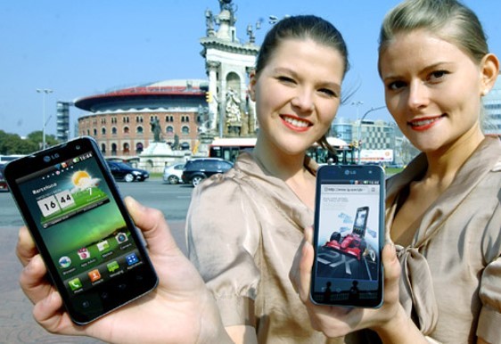 Two women pose with the LG Optimus 2X