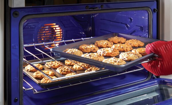 A tray of cookies is being taken from the LG Oven, with baking made easy via its LG ProBake Convection®