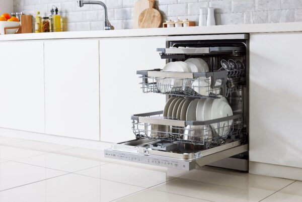 A view of a fitted LG Dishwasher with QuadWashTM the door open to show it full of clean dishes, pots and glasses