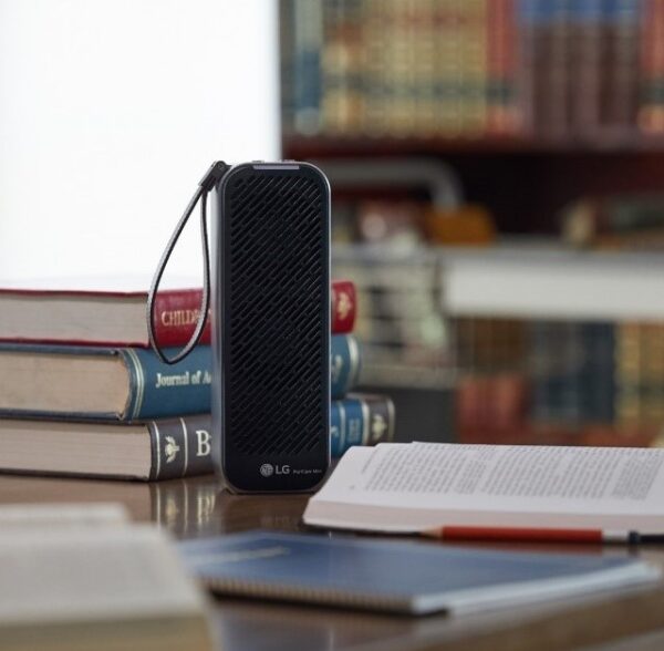 The front view of LG PuriCare Mini Air Purifier surrounded by books.