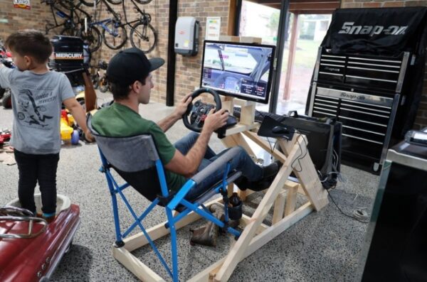 Rick Kelly, a supercar racer, experiencing his beloved sport online with his homemade racing simulator