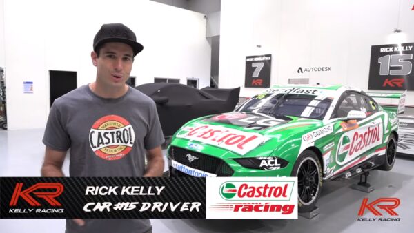 Racing driver Rick Kelly being interviewed in front of his green Ford Mustang GT