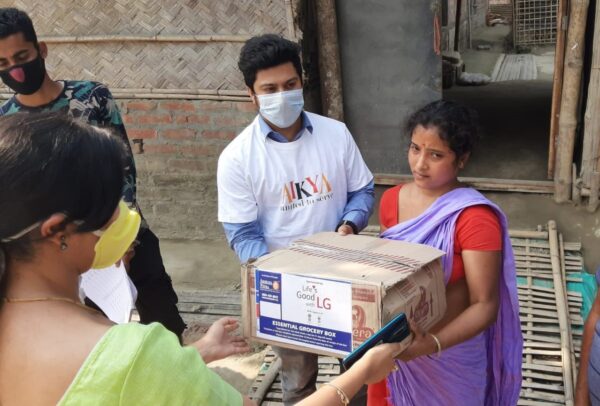 A man and woman in India gifting LG products to others