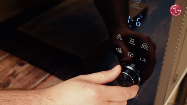 A close-up of Chef Marques using the LG NeoChef microwave oven’s user interface 