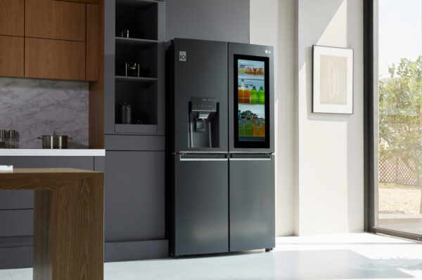 A kitchen with LG InstaView Door-in-Door refrigerator with UVnano showing its inside with InstaView becoming transparent