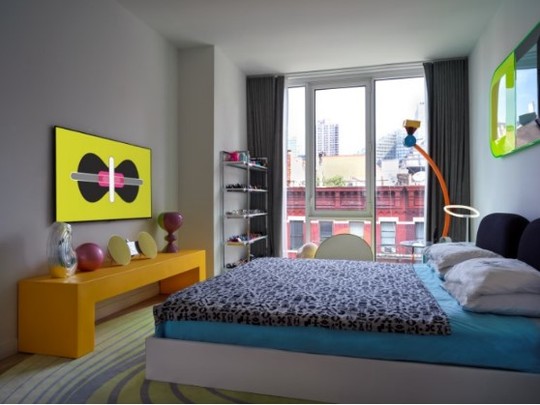A uniquely decorated bedroom with one of LG’s GALLERY DESIGN TVs displaying Karim Rashid’s KARMA on the left-side wall