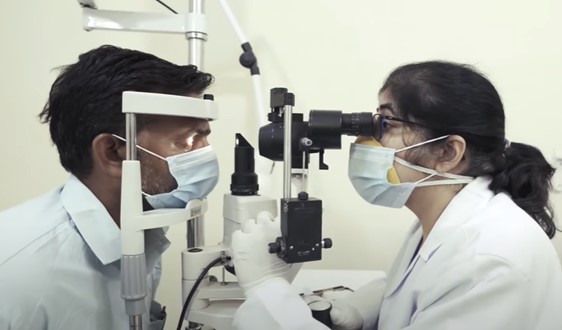 A doctor providing the proper medical care needed by giving a patient a thorough eye exam