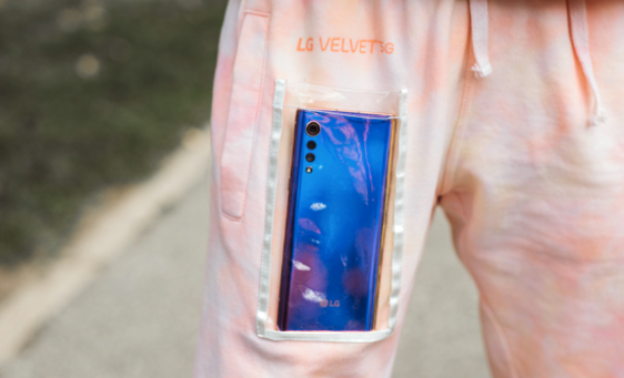 LG VELVET 5G placed inside the transparent pocket of a tie-dye tracksuit designed by Beurd.