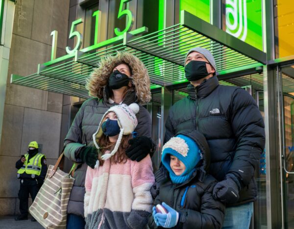 A family watching the documentary on LG's giant screen in New York City's Times Square.