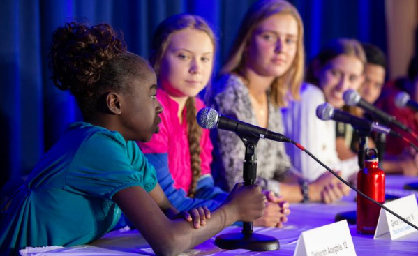  A 12-year-old girl discussing environmental issues with other inspiring young individuals, including Greta Thunberg, during a United Nations Committee event