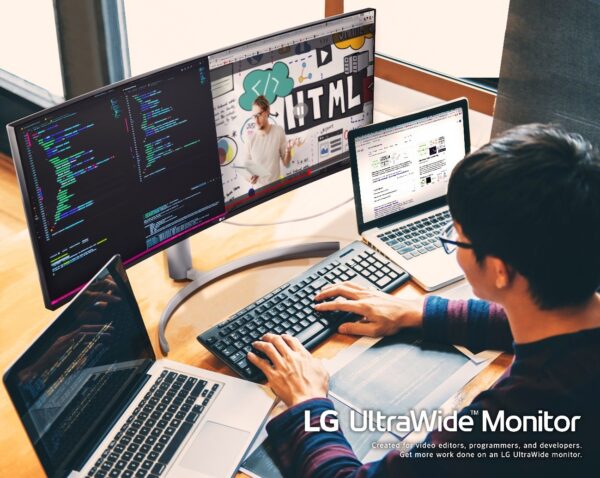 A computer programmer using the LG UltraWide Monitor with two laptops to multitask while working from home.