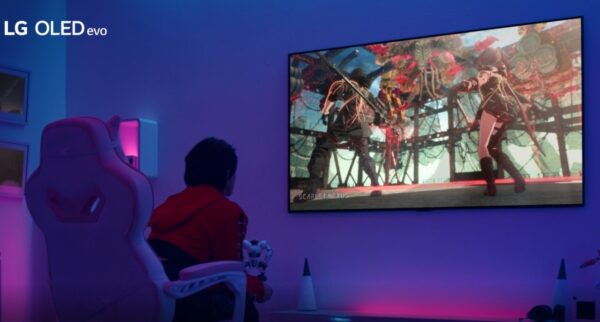 A gamer playing on LG OLED TV in a room boasting atmospheric purple and blue lighting