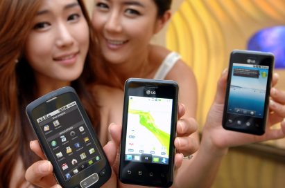 Two models hold up two variants of the LG Optimus Chic and one of the LG Optimus One side-by-side.