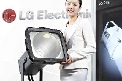 A woman poses holding LG’s Plasma Lighting System (PLS) product in front of LG Electronics' logo