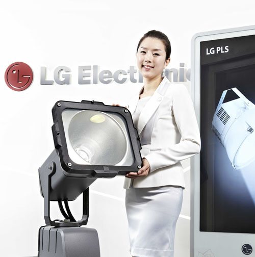 A woman poses holding LG’s Plasma Lighting System (PLS) product in front of LG Electronics' logo