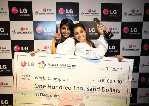 Winners of the LG Mobile Worldcup Championship 2010-2011, Cristina Sales Ancines and Jennifer Sales Ancines from Panama, pose with their award and winnings.