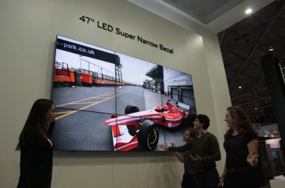 A woman showcasing the 47-inch LED Super Narrow Bezel Display to visitors at ISE 2011