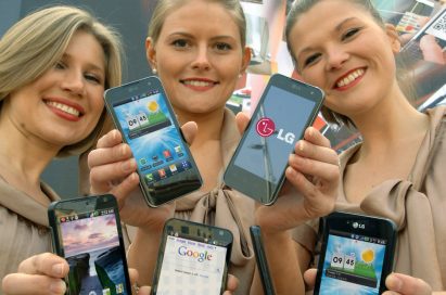 Three female models hold LG Optimus 3D, LG Optimus 2X and LG Optimus Black and show its front views at MWC 2011 event venue