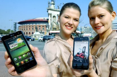 Two female models hold LG Optimus 2Xs and show its front views