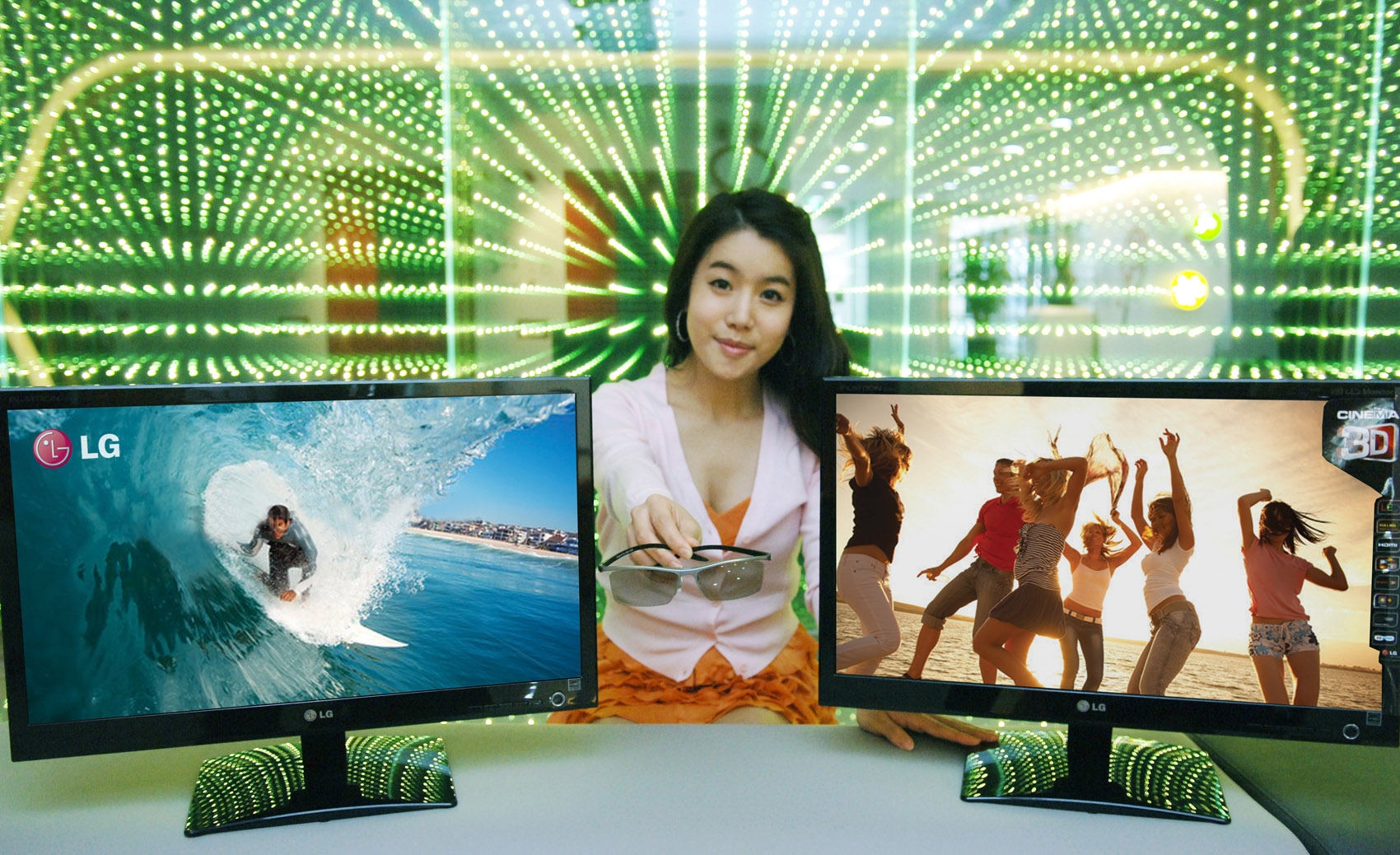 A model is presenting the LG Cinema 3D Monitor on the desk