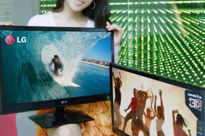 A model wearing 3D glasses is presenting two LG Cinema 3D Monitors