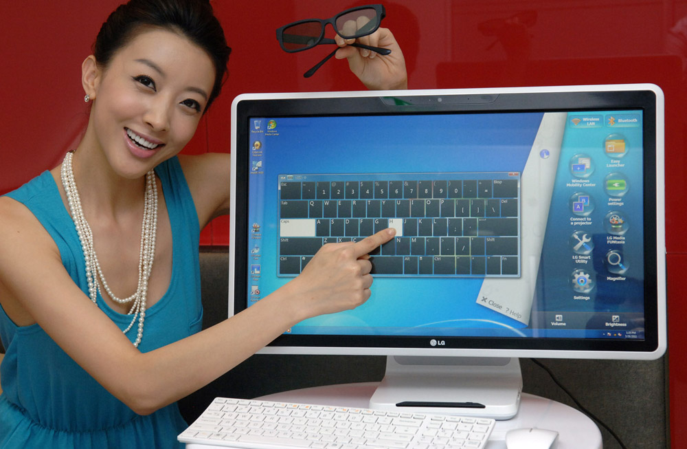 Another marketing image of a model pointing at the touch screen of the LG ALL-IN-ONE PC